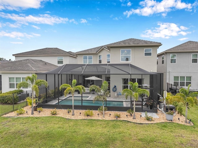 32490 Tree Of Life Ave, Wesley Chapel, FL 33543 - rear view of property with stucco siding, a patio area, and glass enclosure