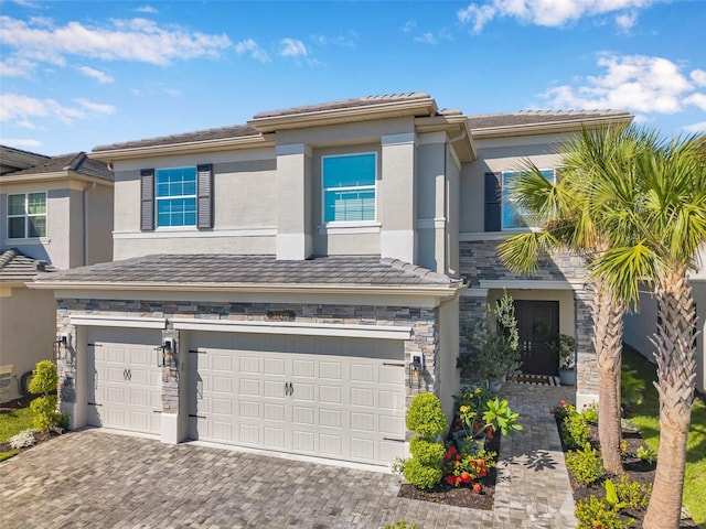 32490 Tree Of Life Ave, Wesley Chapel, FL 33543 - prairie-style home with a garage, stone siding, driveway, and stucco siding