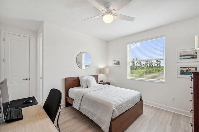 32490 Tree Of Life Ave, Wesley Chapel, FL 33543 - bedroom with light wood-style flooring, a desk, and a ceiling fan