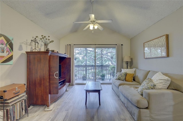 2500 Winding Creek Blvd Unit G307, Clearwater, FL 33761 - living room featuring ceiling fan, light wood-style floors, lofted ceiling, and a textured ceiling