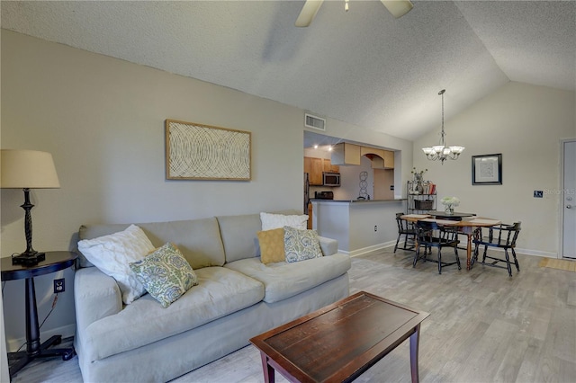 2500 Winding Creek Blvd Unit G307, Clearwater, FL 33761 - living area featuring a chandelier, vaulted ceiling, light wood finished floors, baseboards, and ceiling fan