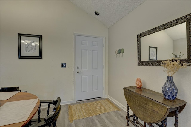 2500 Winding Creek Blvd Unit G307, Clearwater, FL 33761 - foyer entrance with lofted ceiling, light wood-style floors, baseboards, and a textured ceiling