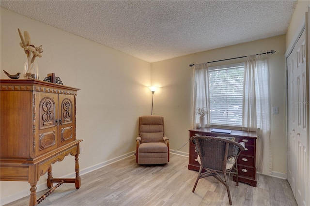 2500 Winding Creek Blvd Unit G307, Clearwater, FL 33761 - home office with light wood-style floors, a textured ceiling, and baseboards