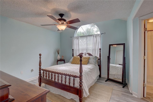 2500 Winding Creek Blvd Unit G307, Clearwater, FL 33761 - bedroom featuring light wood-type flooring, a textured ceiling, baseboards, and a ceiling fan