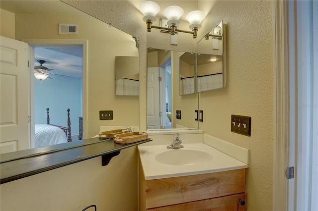 2500 Winding Creek Blvd Unit G307, Clearwater, FL 33761 - ensuite bathroom featuring a ceiling fan, vanity, and a textured wall