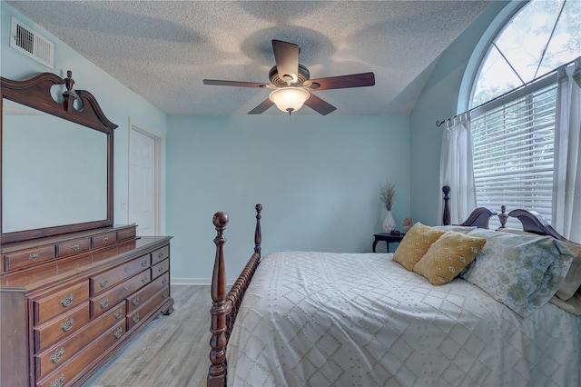 2500 Winding Creek Blvd Unit G307, Clearwater, FL 33761 - bedroom with light wood-style floors, a ceiling fan, and a textured ceiling