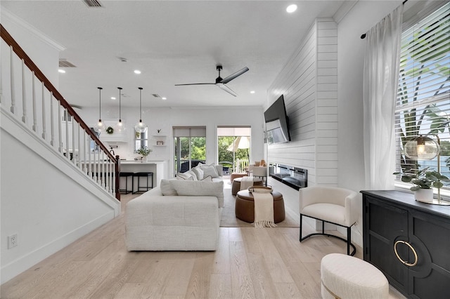6512 Simone Shores Cir, Apollo Beach, FL 33572 - living area with a fireplace, stairs, light wood finished floors, a ceiling fan, and recessed lighting