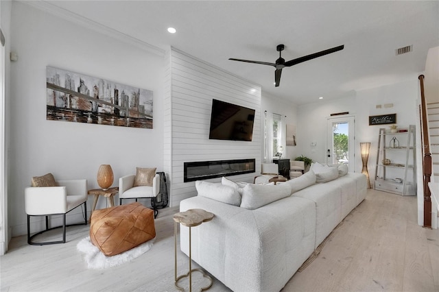 6512 Simone Shores Cir, Apollo Beach, FL 33572 - living area with light wood-type flooring, ceiling fan, crown molding, recessed lighting, and a fireplace