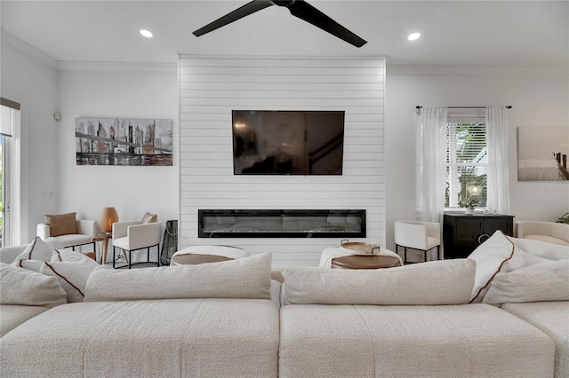 6512 Simone Shores Cir, Apollo Beach, FL 33572 - living area with a large fireplace, ornamental molding, a ceiling fan, and recessed lighting