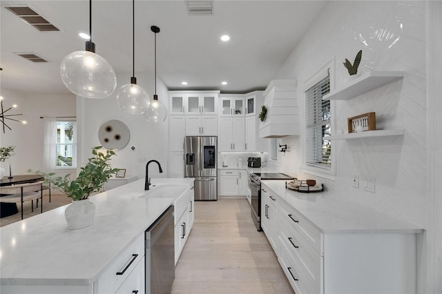6512 Simone Shores Cir, Apollo Beach, FL 33572 - kitchen featuring appliances with stainless steel finishes, open shelves, tasteful backsplash, a large island, and pendant lighting