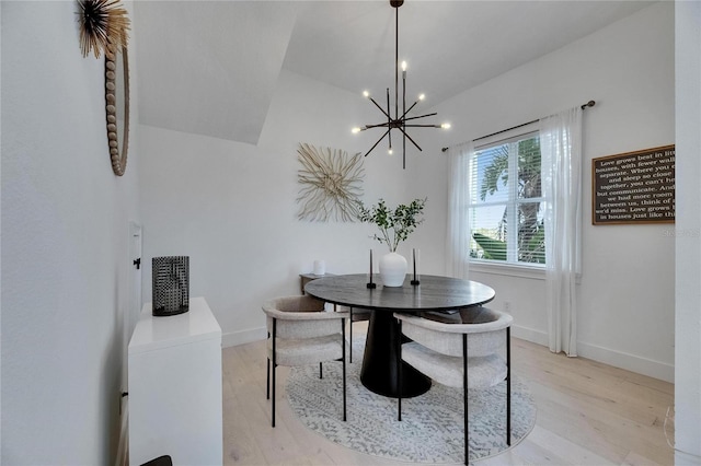 6512 Simone Shores Cir, Apollo Beach, FL 33572 - dining space with a chandelier, light wood-style flooring, baseboards, and lofted ceiling