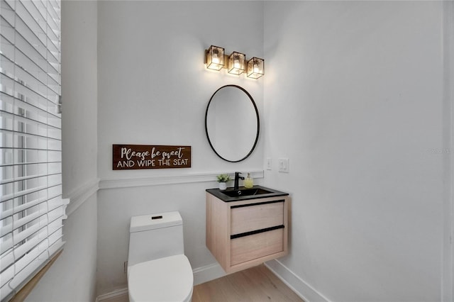6512 Simone Shores Cir, Apollo Beach, FL 33572 - bathroom featuring toilet, vanity, wood finished floors, and baseboards