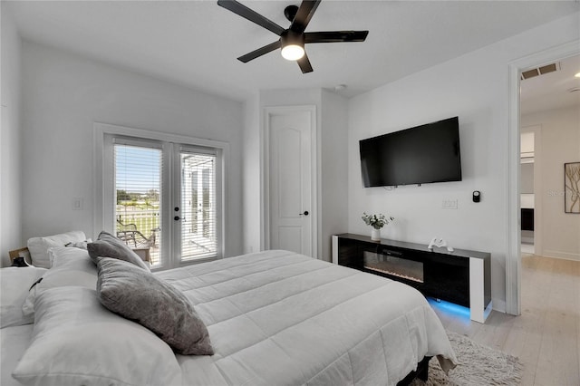 6512 Simone Shores Cir, Apollo Beach, FL 33572 - bedroom with access to exterior, light wood-style flooring, a ceiling fan, and baseboards