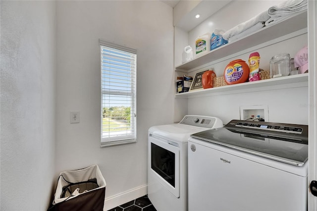 6512 Simone Shores Cir, Apollo Beach, FL 33572 - washroom with washer and dryer, baseboards, healthy amount of natural light, and dark tile patterned floors