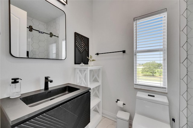 6512 Simone Shores Cir, Apollo Beach, FL 33572 - full bath with marble look tile flooring, toilet, vanity, a shower, and baseboards