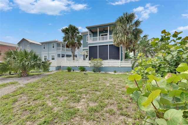 6512 Simone Shores Cir, Apollo Beach, FL 33572 - back of property featuring a ceiling fan, a sunroom, a balcony, and stucco siding