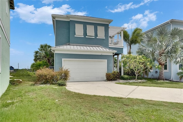 6512 Simone Shores Cir, Apollo Beach, FL 33572 - view of front of house featuring a standing seam roof, a garage, stucco siding, driveway, and a balcony