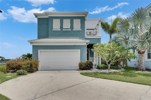 6512 Simone Shores Cir, Apollo Beach, FL 33572 - view of front of home with stucco siding, a garage, a standing seam roof, a balcony, and concrete driveway