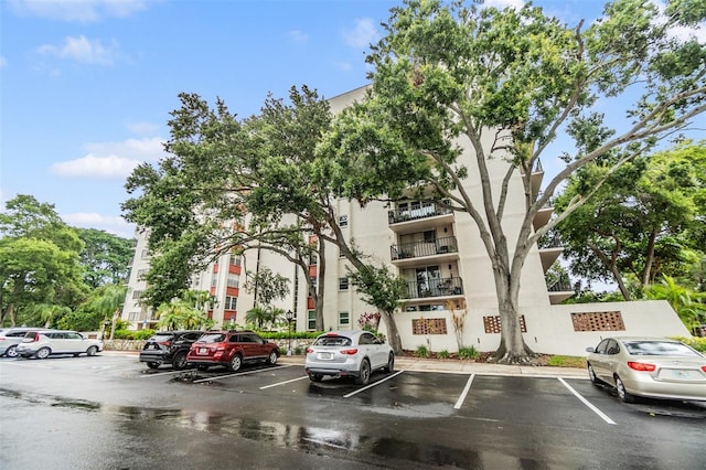 2699 Seville Blvd Unit 207, Clearwater, FL 33764 - view of apartment building / complex featuring uncovered parking