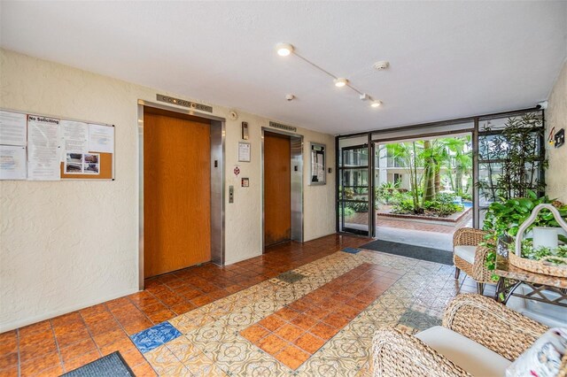 2699 Seville Blvd Unit 207, Clearwater, FL 33764 - building lobby with a textured wall and expansive windows