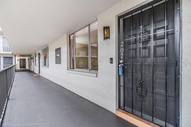 2699 Seville Blvd Unit 207, Clearwater, FL 33764 - doorway to property featuring stucco siding and electric panel