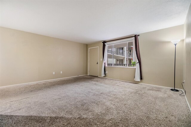 2699 Seville Blvd Unit 207, Clearwater, FL 33764 - carpeted empty room with baseboards