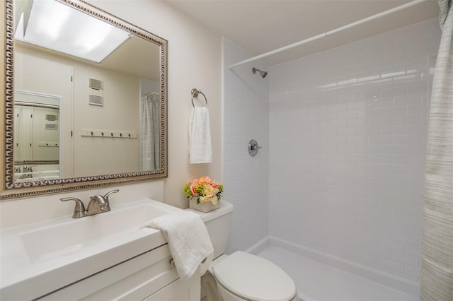 2699 Seville Blvd Unit 207, Clearwater, FL 33764 - bathroom featuring toilet, tiled shower, and vanity