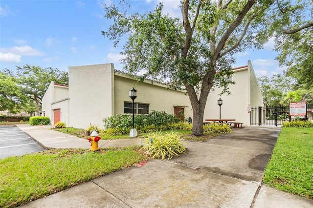 2699 Seville Blvd Unit 207, Clearwater, FL 33764 - view of front of house featuring stucco siding and a gate