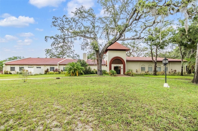 2699 Seville Blvd Unit 207, Clearwater, FL 33764 - mediterranean / spanish house with stucco siding, a tile roof, and a front yard