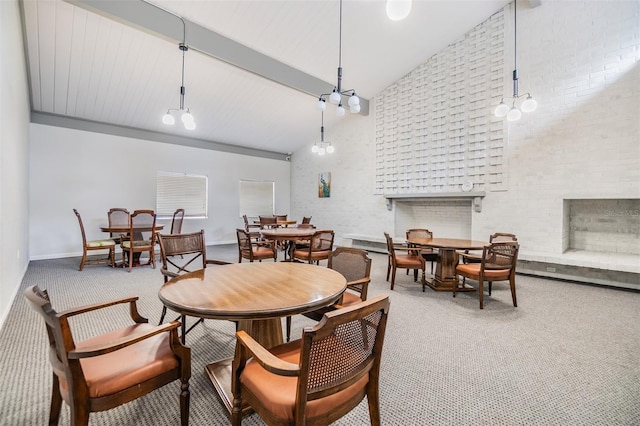 2699 Seville Blvd Unit 207, Clearwater, FL 33764 - dining area featuring carpet flooring, high vaulted ceiling, a fireplace, and baseboards