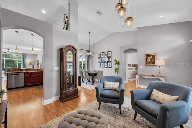 15309 Palomapark Ln, Lithia, FL 33547 - sitting room with arched walkways, light wood-type flooring, baseboards, high vaulted ceiling, and recessed lighting