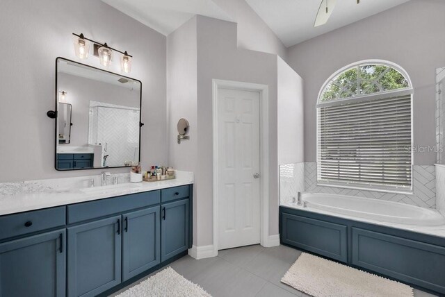 15309 Palomapark Ln, Lithia, FL 33547 - bathroom featuring vanity, a garden tub, and tile patterned flooring