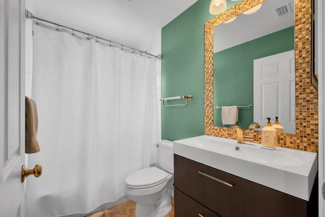 15309 Palomapark Ln, Lithia, FL 33547 - full bath featuring vanity, tasteful backsplash, toilet, and tile patterned floors