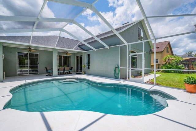 15309 Palomapark Ln, Lithia, FL 33547 - outdoor pool with ceiling fan, a patio, a yard, and glass enclosure