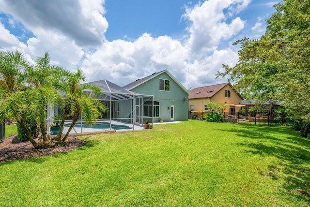 15309 Palomapark Ln, Lithia, FL 33547 - back of property featuring an outdoor pool, glass enclosure, and stucco siding