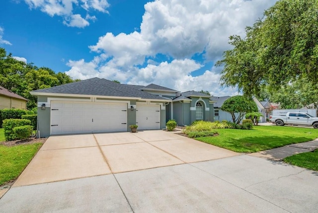 15309 Palomapark Ln, Lithia, FL 33547 - view of front of property featuring an attached garage, a front lawn, concrete driveway, stucco siding, and a shingled roof