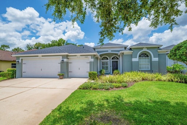 15309 Palomapark Ln, Lithia, FL 33547 - view of front of house with stucco siding, a garage, concrete driveway, and a front yard