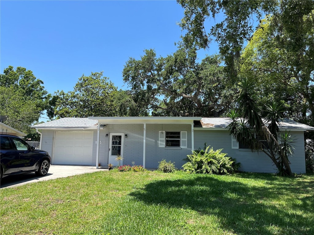 835 5th St, Port Orange, FL 32129 - ranch-style home featuring an attached garage, a front lawn, and driveway