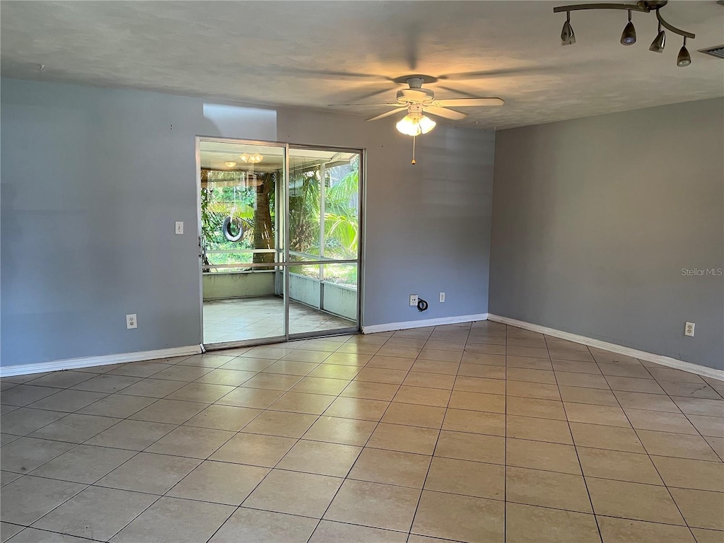 835 5th St, Port Orange, FL 32129 - empty room featuring ceiling fan, light tile patterned floors, and baseboards