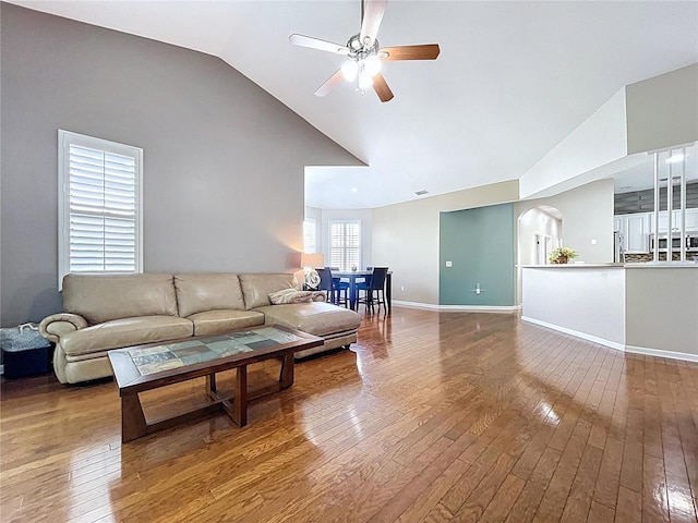776 Grasslands Village Cir Unit 776, Lakeland, FL 33803 - living room featuring a ceiling fan, hardwood / wood-style flooring, arched walkways, and high vaulted ceiling