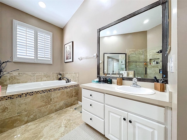 776 Grasslands Village Cir Unit 776, Lakeland, FL 33803 - bathroom featuring vanity, a garden tub, and a stall shower