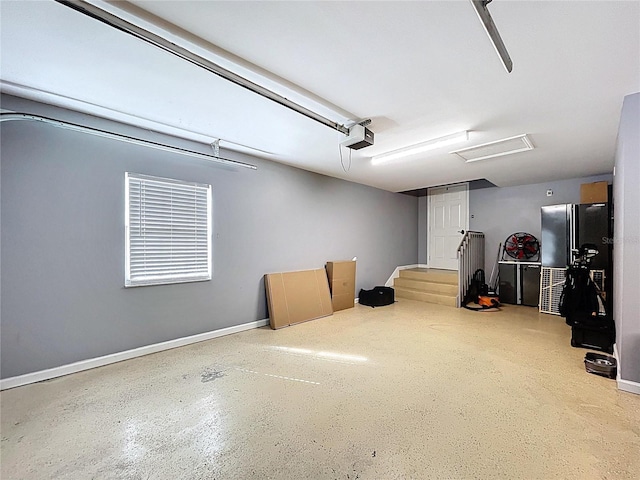 776 Grasslands Village Cir Unit 776, Lakeland, FL 33803 - garage with a garage door opener and freestanding refrigerator