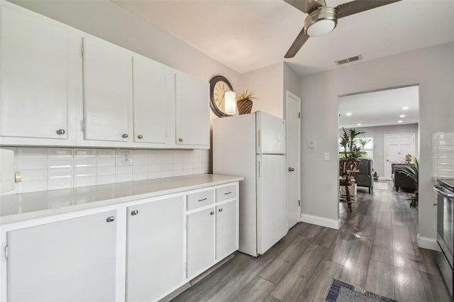 5728 14th Ave N Unit 101B, Saint Petersburg, FL 33710 - kitchen featuring freestanding refrigerator, light countertops, a ceiling fan, dark wood-style flooring, and white cabinetry