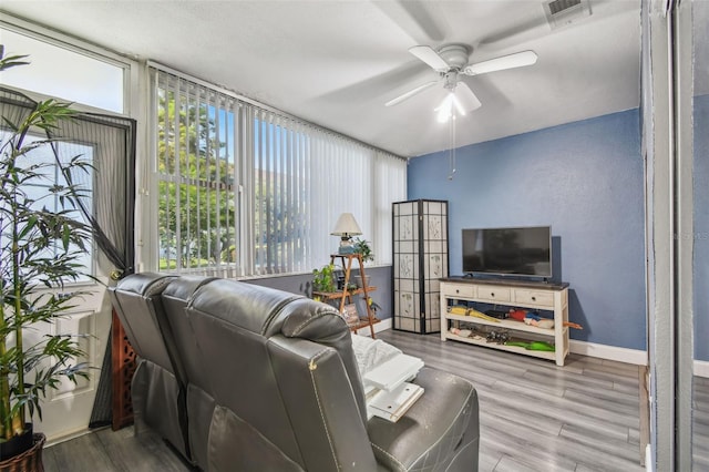 5728 14th Ave N Unit 101B, Saint Petersburg, FL 33710 - living room with ceiling fan, baseboards, and wood finished floors