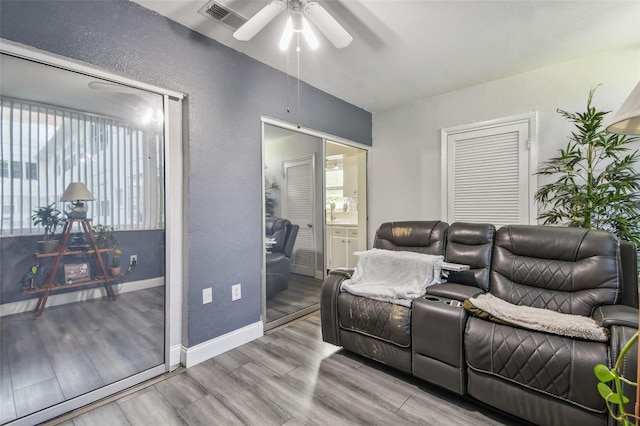 5728 14th Ave N Unit 101B, Saint Petersburg, FL 33710 - living area featuring ceiling fan, wood finished floors, a textured wall, and baseboards