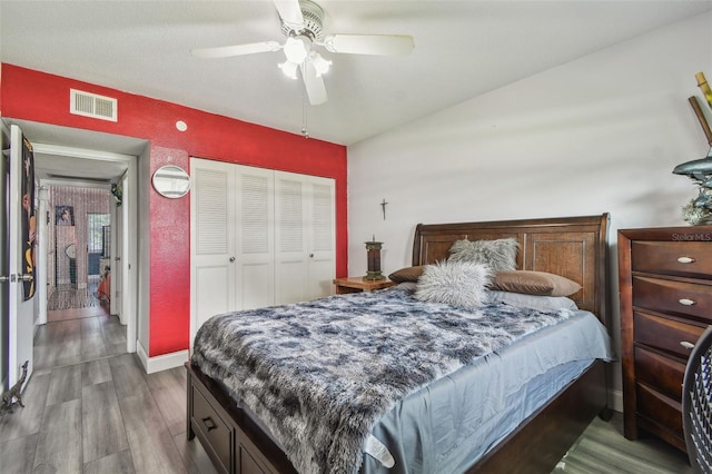 5728 14th Ave N Unit 101B, Saint Petersburg, FL 33710 - bedroom with wood finished floors, a closet, a ceiling fan, and baseboards