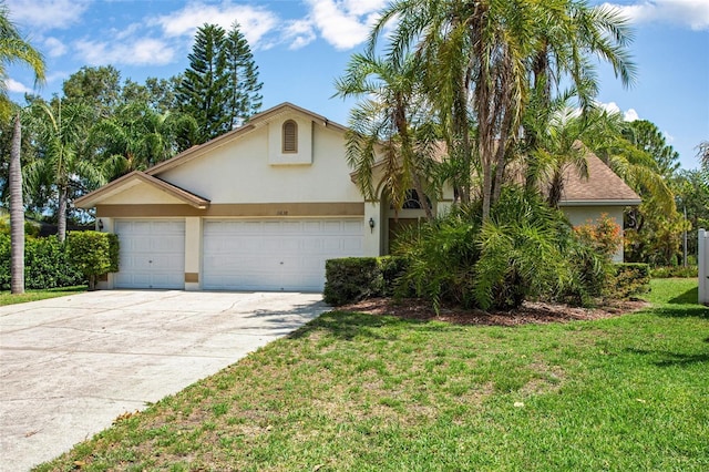 11638 Branch Mooring Dr, Tampa, FL 33635 - view of front of home featuring stucco siding, an attached garage, driveway, and a front lawn