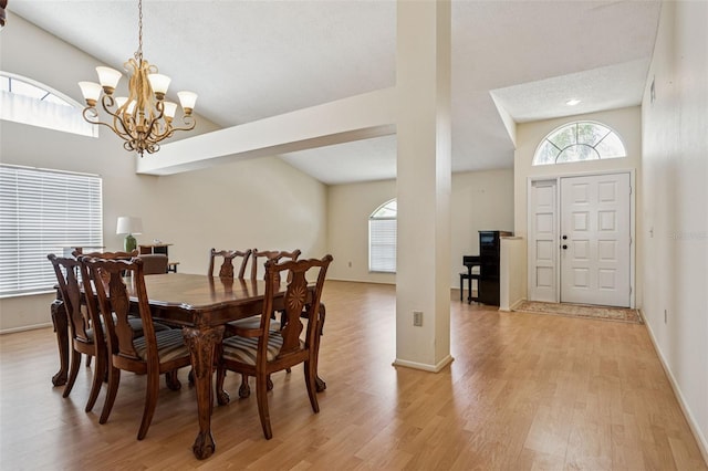 11638 Branch Mooring Dr, Tampa, FL 33635 - dining area featuring light wood-style floors, a chandelier, baseboards, and lofted ceiling