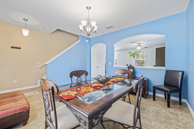 12244 Fairlawn Dr, Riverview, FL 33579 - dining room featuring arched walkways, a chandelier, and ceiling fan