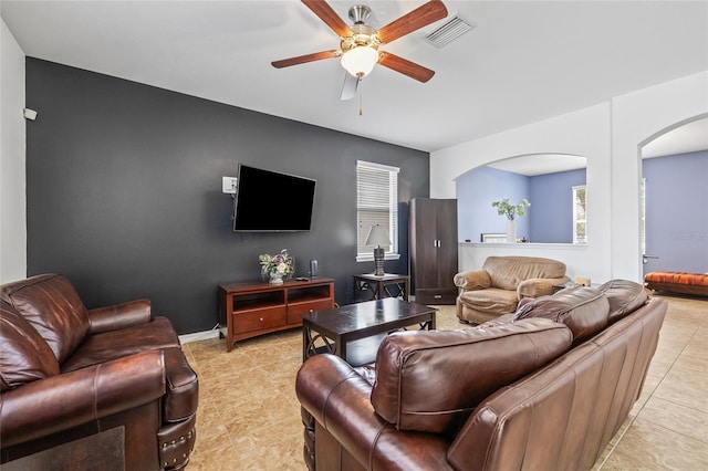 12244 Fairlawn Dr, Riverview, FL 33579 - living room with arched walkways, a ceiling fan, and light tile patterned floors